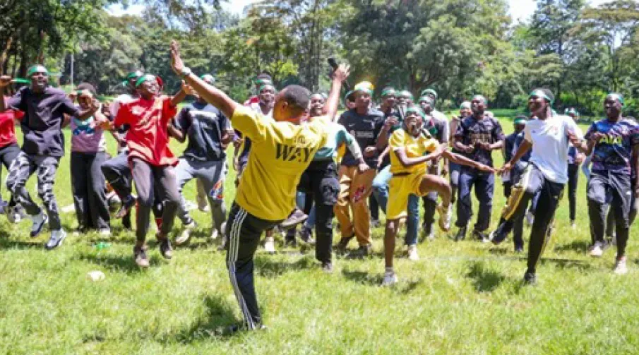 sponsored children and Spur staff dancing to music at picnic (Rowland's Scouts Camp)